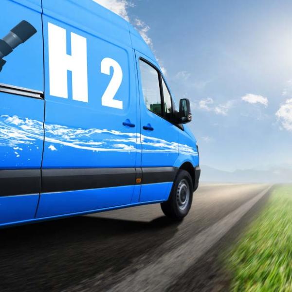 Blue van with an 'H2' hydrogen pump logo